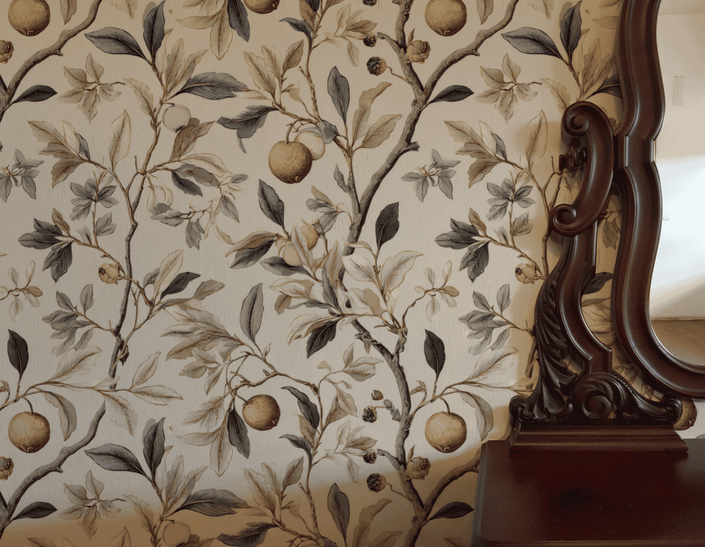 The right side of the image features the ornate wooden frame of a mirror next to Botanical Elegance Wallpaper, which displays floral and fruit patterns with golden fruit accents and apple branches.