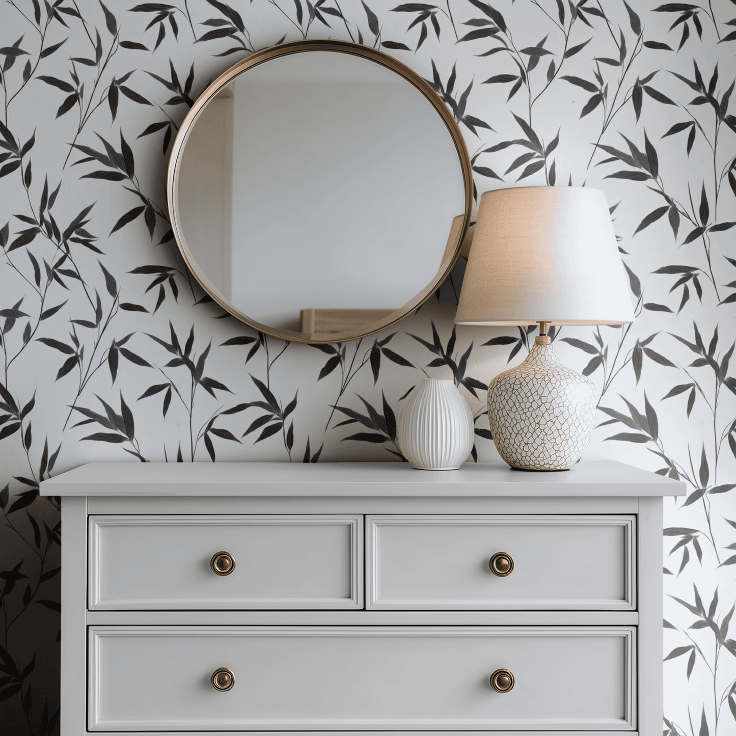 White Botanical Wallpaper shown in a second interior with the dark ebony foliage reading as graphic high-contrast decoration