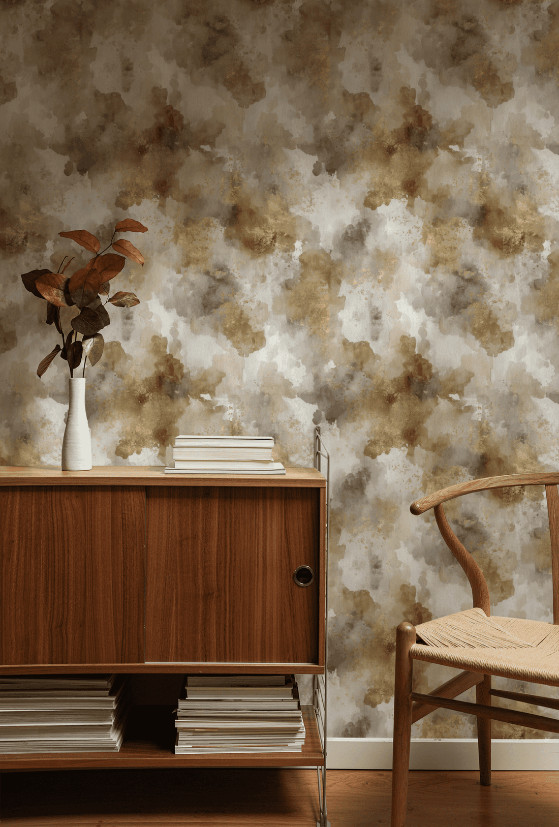 Metallic wallpaper with gold-leaf accents catching light against a dark ground