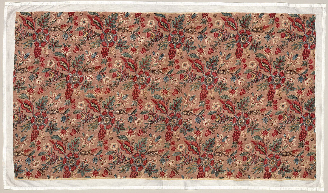 Toile fabric showing pastoral French country scenes printed in red on a cream cotton ground