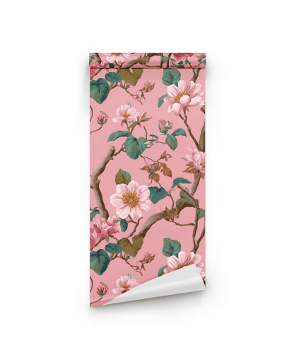 Floral Serenity Wallpaper features a soft pink background adorned with delicate blooms, green leaves, and elegant branches in a striking floral pattern.