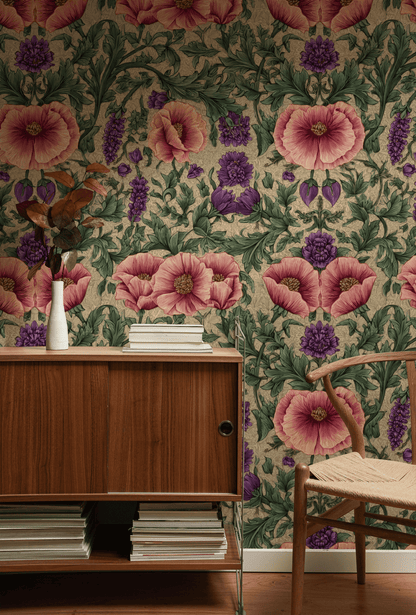 A wooden sideboard with stacked books and a vase of dried leaves sits before the Blooming Reverie Wallpaper, creating a romantic feel. Beside the sideboard is a wooden chair with a woven seat.
