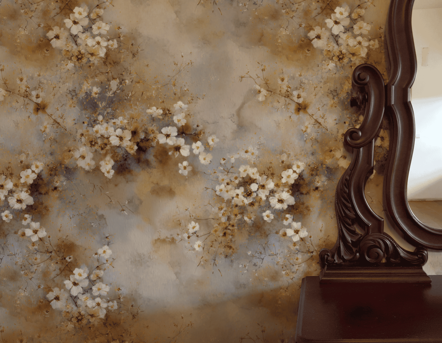 Ethereal Blossom Wallpaper, featuring muted watercolor florals, is paired with an ornate dark wood mirror frame that reflects a light-colored wall, creating a tranquil atmosphere in the space.