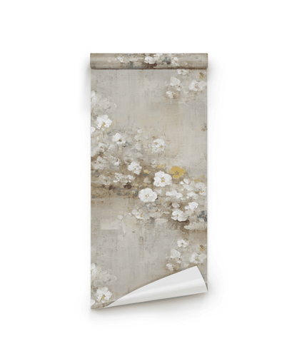 The Bloom Serenity Wallpaper features a muted floral pattern with white and pale yellow flowers on a beige background, accented by a delicate painterly texture. The roll is partially unrolled for display.
