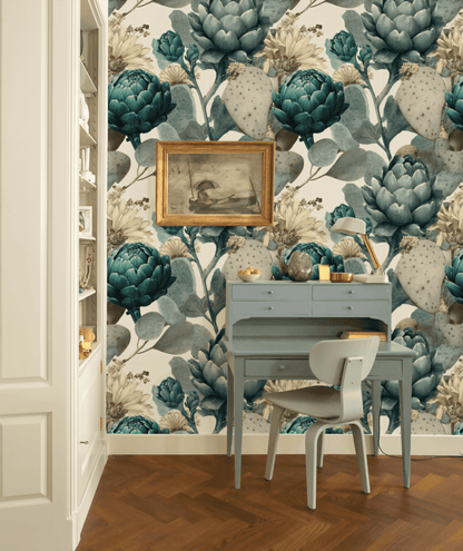 A small blue desk and chair are set against a wall adorned with Botanical Elegance Wallpaper; a framed painting hangs above the desk, and shelves are visible on the left.