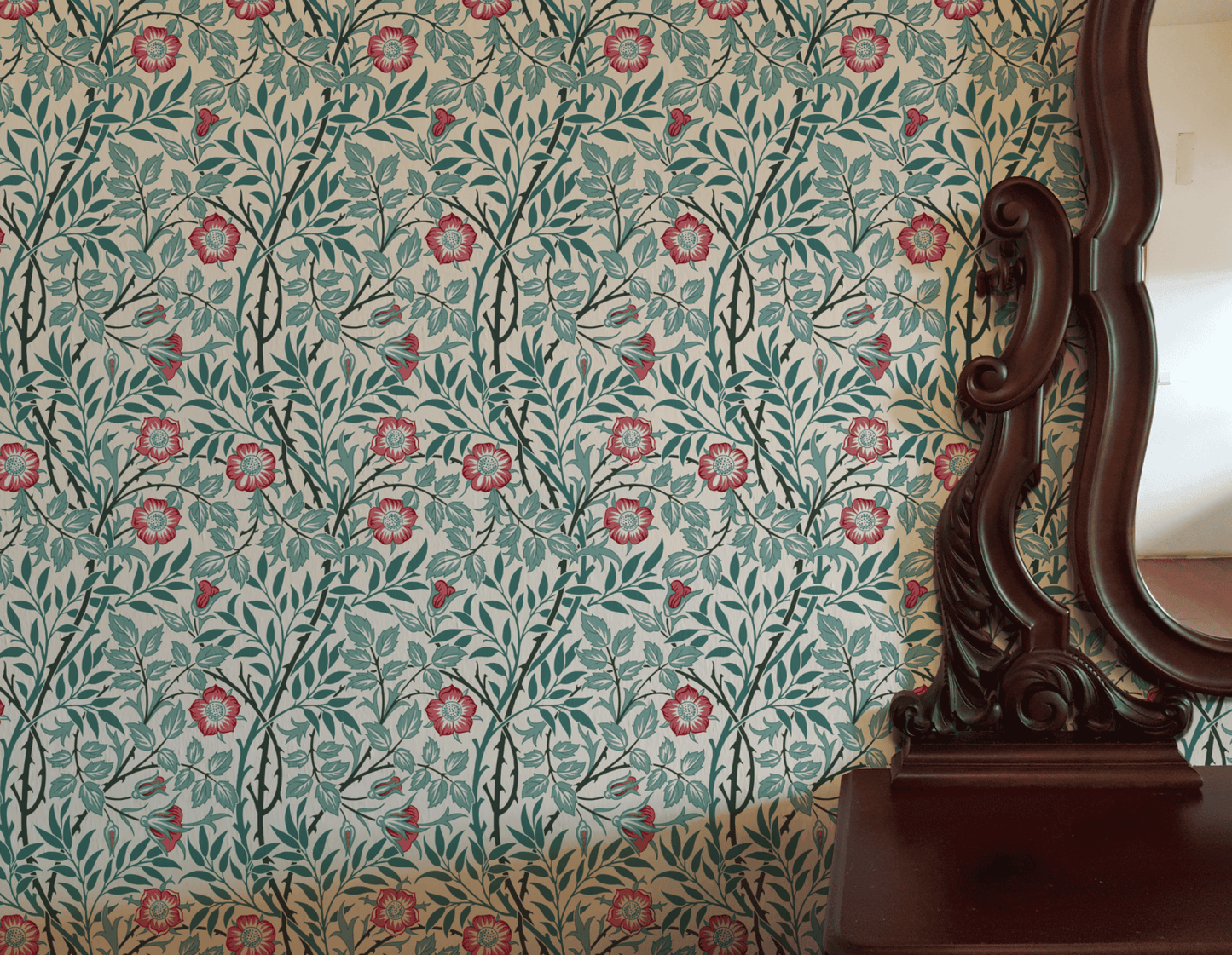 Red Floral Wallpaper installed on a room wall with the Morris sweet briar rose design in warm light Victorian palette