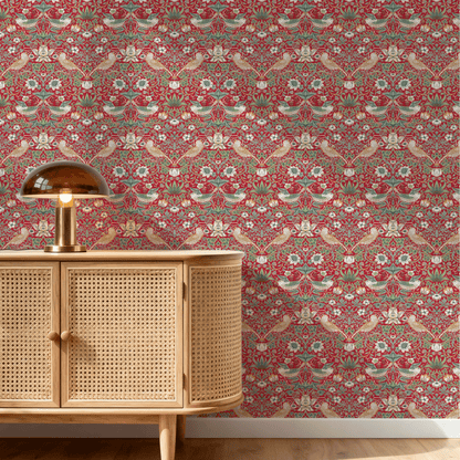Red Bird Pattern Wallpaper installed on a room wall with the iconic 1883 Morris thrushes-among-strawberries design in deep heritage red