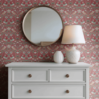 Red Bird Pattern Wallpaper shown in a second interior with the heritage red Strawberry Thief reading as the iconic Morris decoration in its original palette