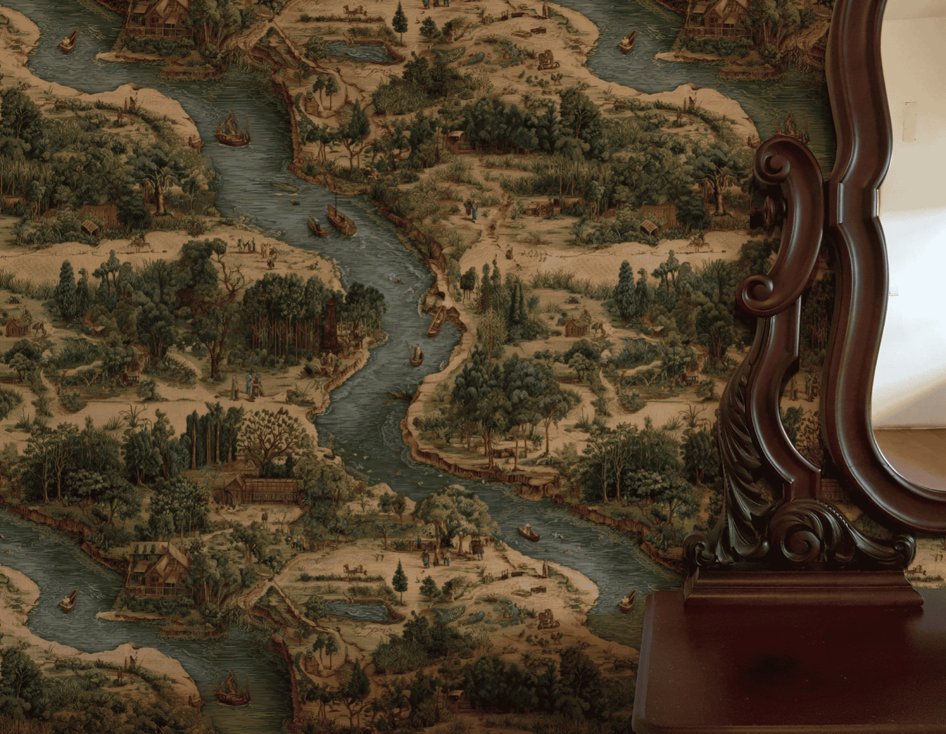 A vintage wooden mirror stands beside Riverside Tale Wallpaper, which features a whimsical landscape of flowing rivers, trees, boats, and small houses in muted colors.