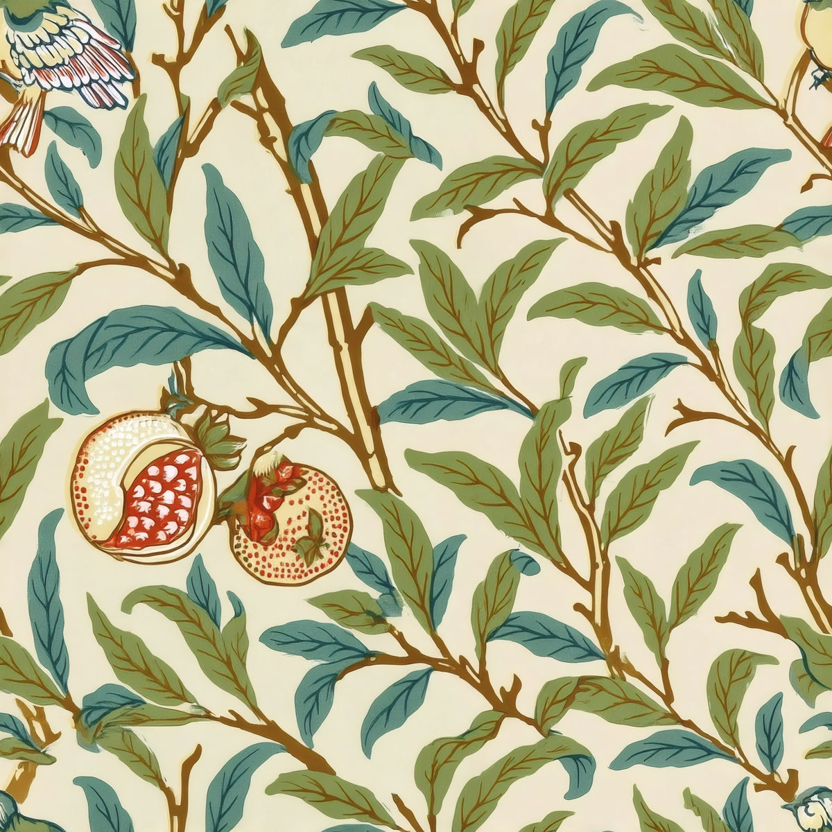 Slender green and teal leaves, split pomegranates and small birds wind across a warm cream ground, a William Morris design.