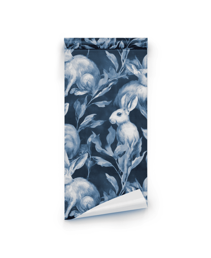 Indigo Rabbit wallpaper features serene rabbits in indigo tones nestled among lush foliage on a crisp white background.