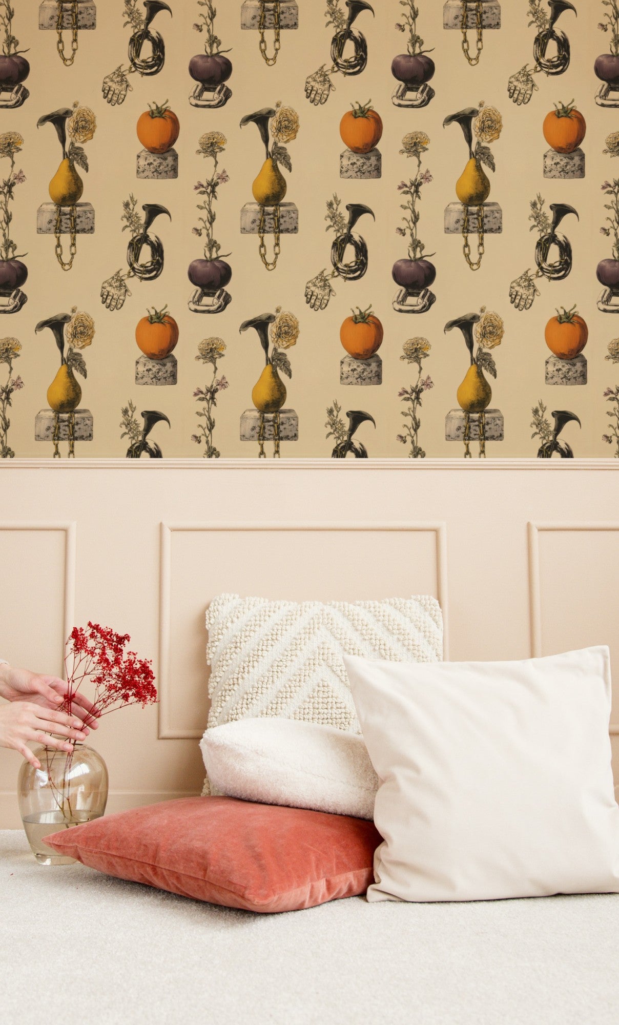 Surreal still-life wallpaper of pears and tomatoes on cinderblocks with chains, a hand and calla lilies on cream. - room view
