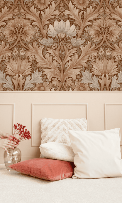 Antique Flora Wallpaper above beige wainscoting exudes timeless charm, while white and red pillows and a hand arranging red flowers in a glass vase complete the elegant scene.