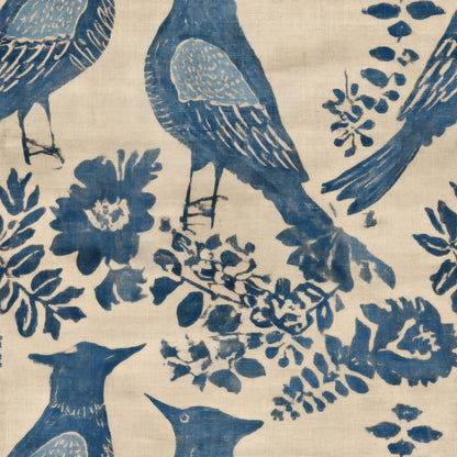 Block printed birds in indigo blue among flowers and sprigs on flax linen, hand-printed style.