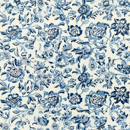 A dense trail of blue flowers and leaves in Delft blues on a white ground, a William Morris design.