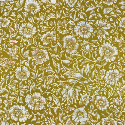 Small cream mallow flowers and leaves form a dense all-over pattern on a mustard ground, a William Morris design.