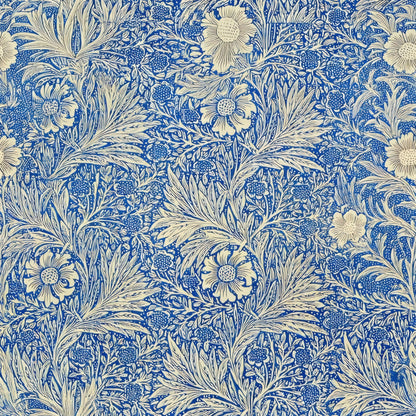 Cream marigold flowers and feathery leaves over fine cobalt-blue foliage, a William Morris design.