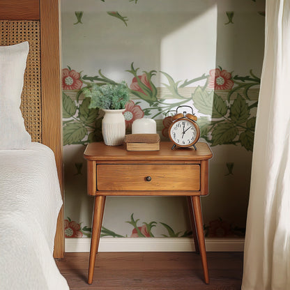William Morris Rambler Rose wallpaper on a wall — Bedside table with clock scene