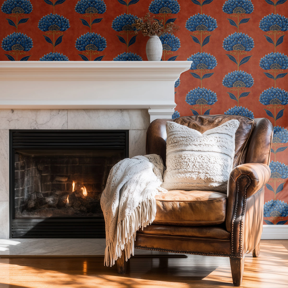 Terracotta Bloom wallpaper on a wall behind a wingback chair by the fire