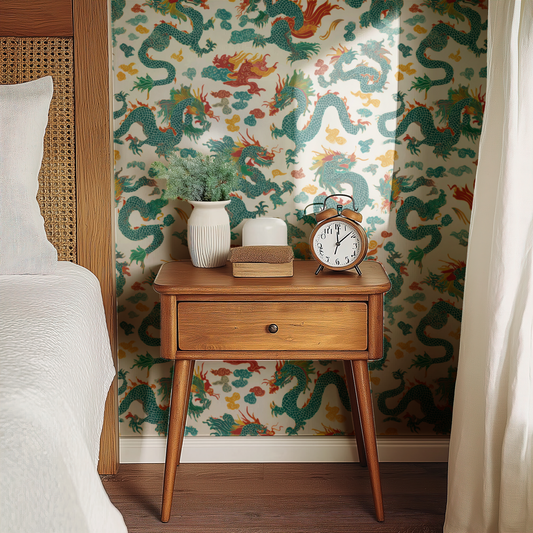Jade Dynasty wallpaper with chinoiserie florals in cream and jade green, shown installed on a living-room wall at room scale