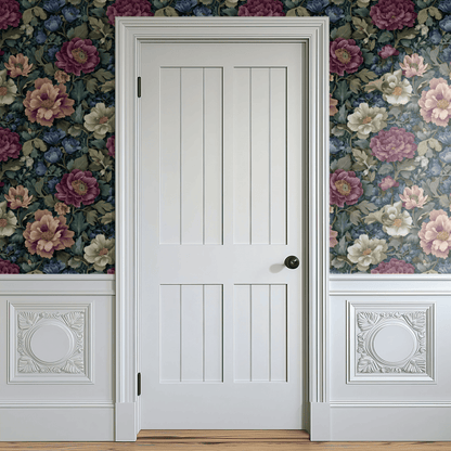 Green Floral Wallpaper shown in a second room with the dense fern fronds anchoring the wall and the green palette pairing against warm wood