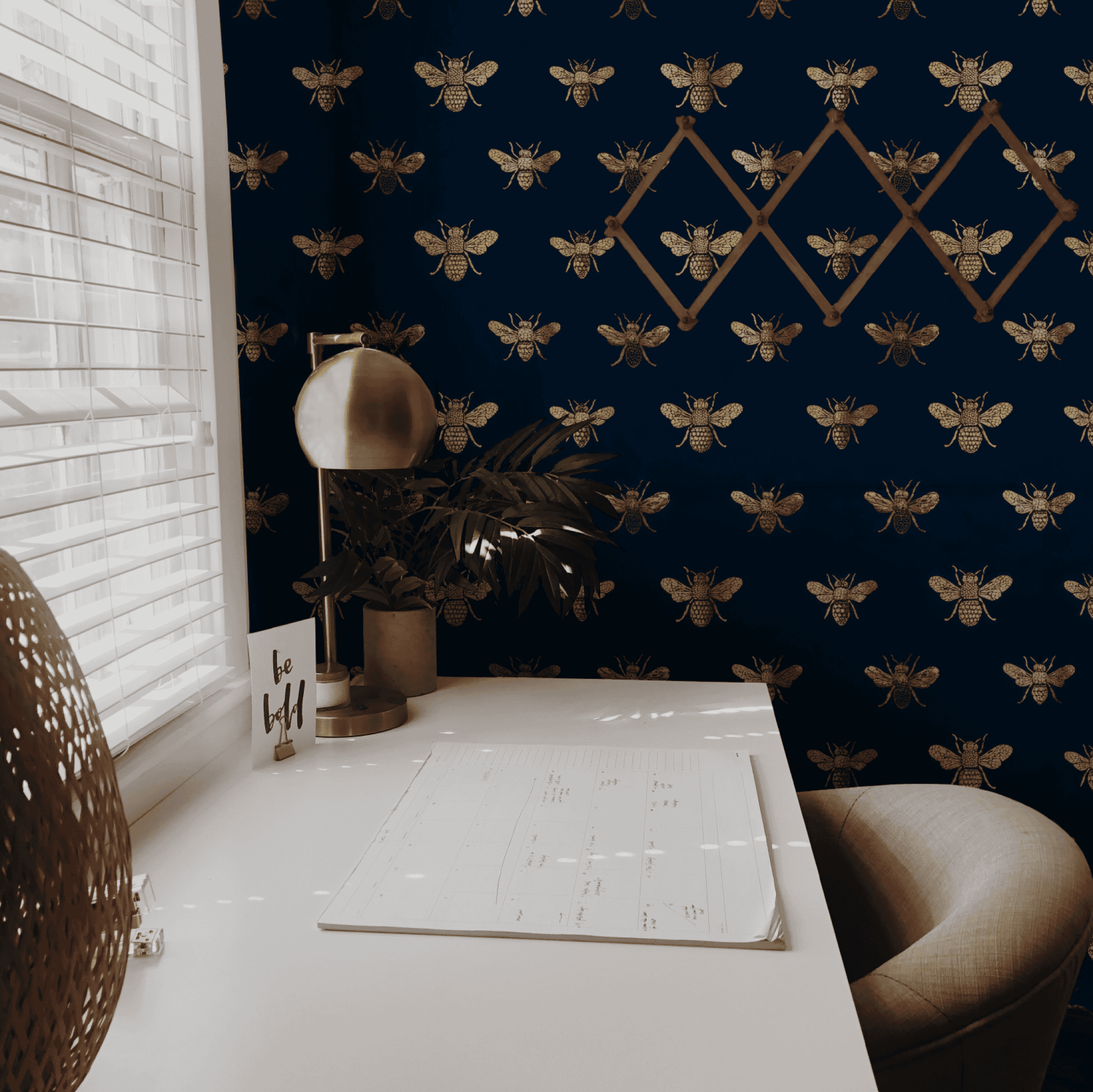 Blue Animal Print Wallpaper installed in a room interior with naturalistic bees in metallic bronze on a blue ground