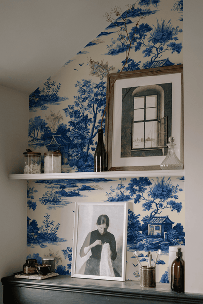 Blue Toile Wallpaper installed on a room wall with blue scenic toile of pavilions and Chinese landscape