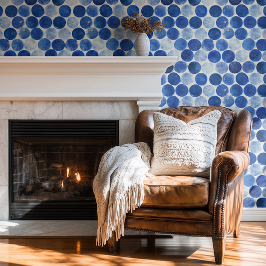 Azure Polka wallpaper with block-print geometric polka dot pattern in deep azure blue, shown installed on a living-room wall at room scale
