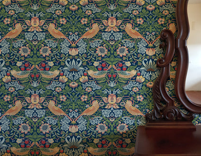 Blue Bird Pattern Wallpaper installed in a room interior with the iconic 1883 Morris thrushes-among-strawberries design in deep indigo blue