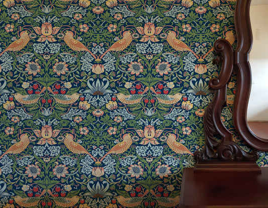 Blue Bird Pattern Wallpaper installed in a room interior with the iconic 1883 Morris thrushes-among-strawberries design in deep indigo blue