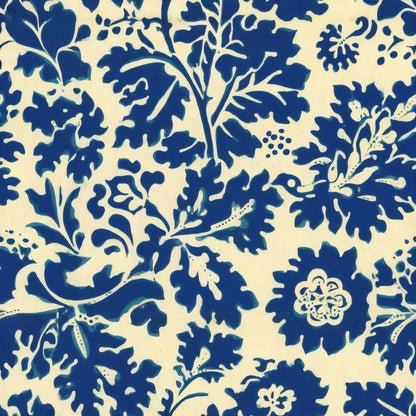 Bold indigo leaves and flowers in a single-colour print on a warm cream ground, a William Morris design.