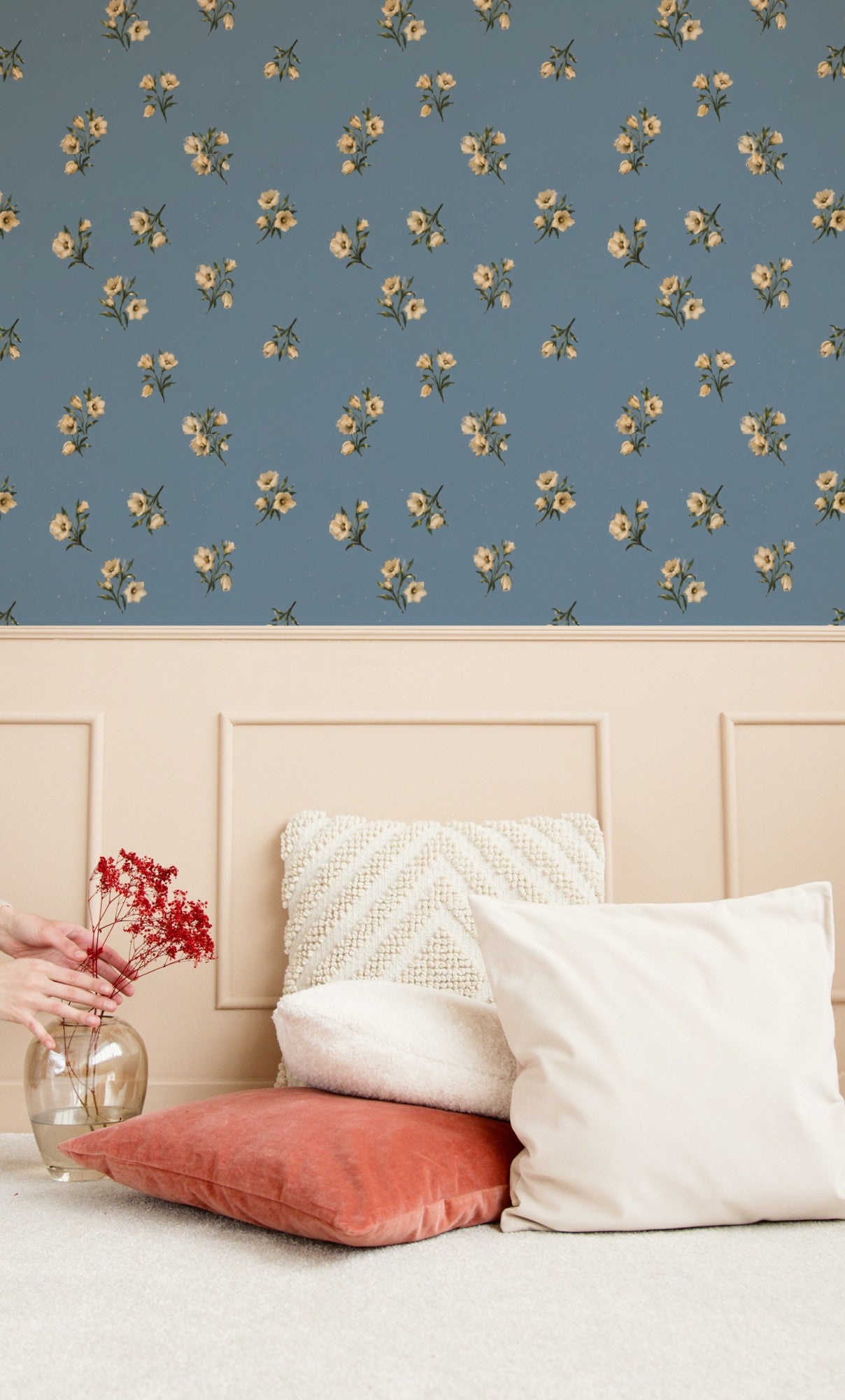 Cream wildflower sprigs scattered across a soft dusty-blue ground in a delicate painterly ditsy wallpaper. - room view